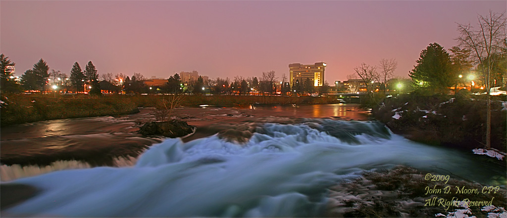 The Spokane River's North river channel flows past the Pavillion area, and IMAX Theater on the right.