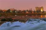 The Spokane River's North river channel flows past the Pavillion area, and IMAX Theater on the right.