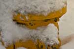 Snow covered fire hydrant in early Spokane darkness as street lights begin to illuminate the area.  