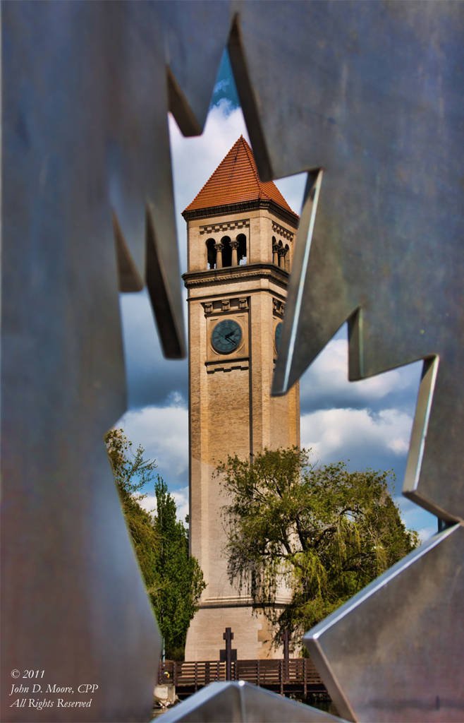 The Clocktower as viewed through a sculpture of the Canadian Flag.  Spokane, Washington.