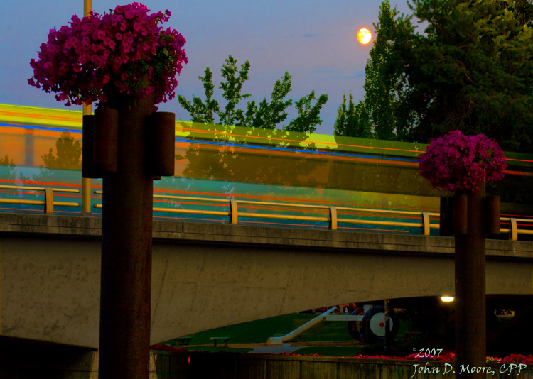 Enroute to downtown Spokane, an STA bus adds motion and color to an early evening in Spokane